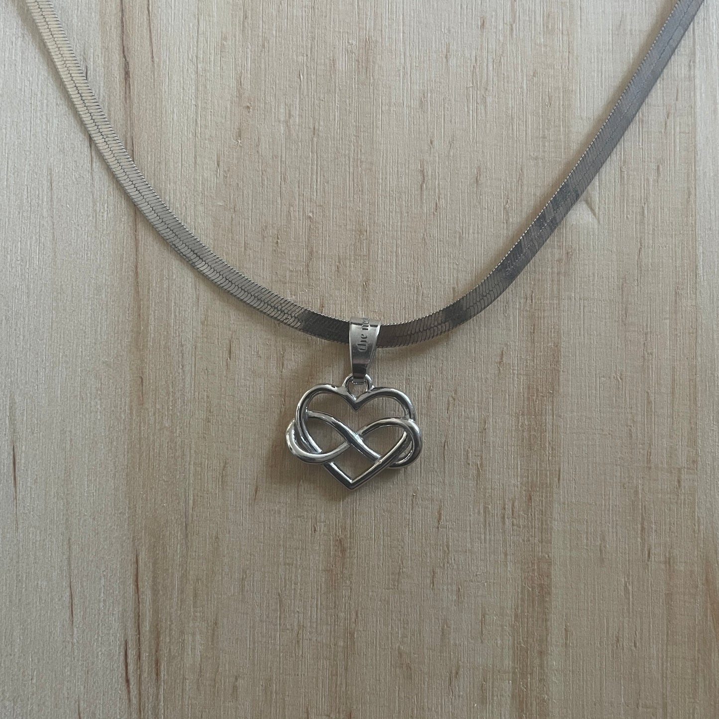 the INFINITE LOVE charm