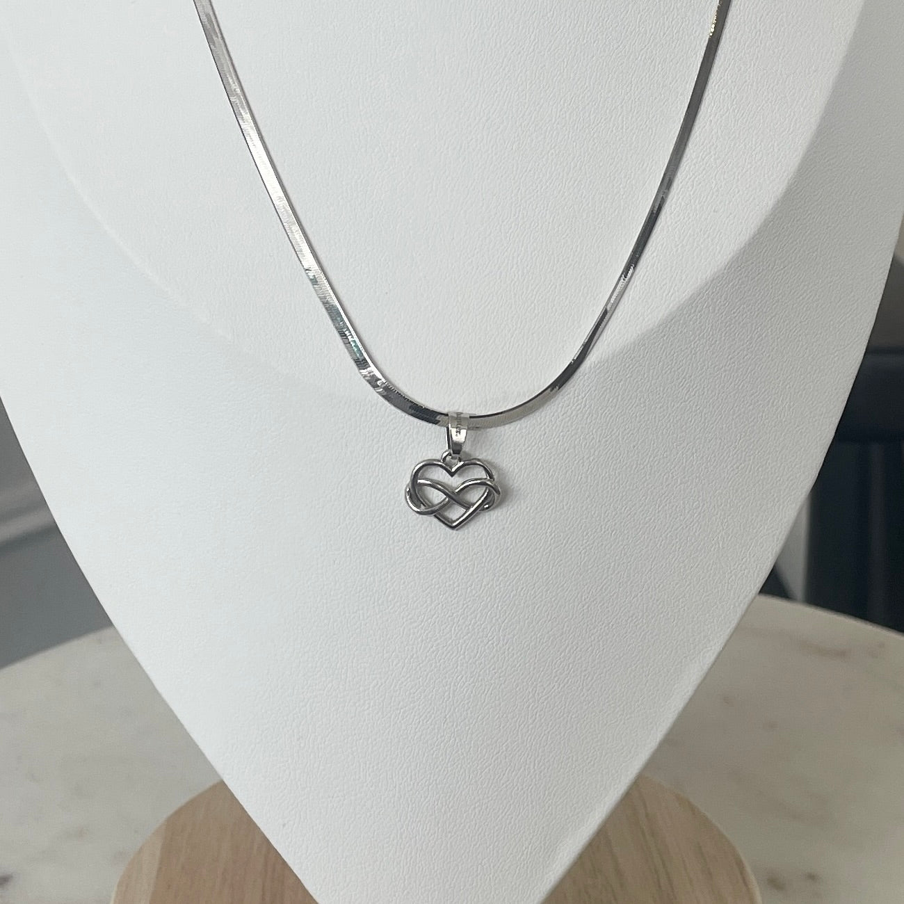 the INFINITE LOVE charm