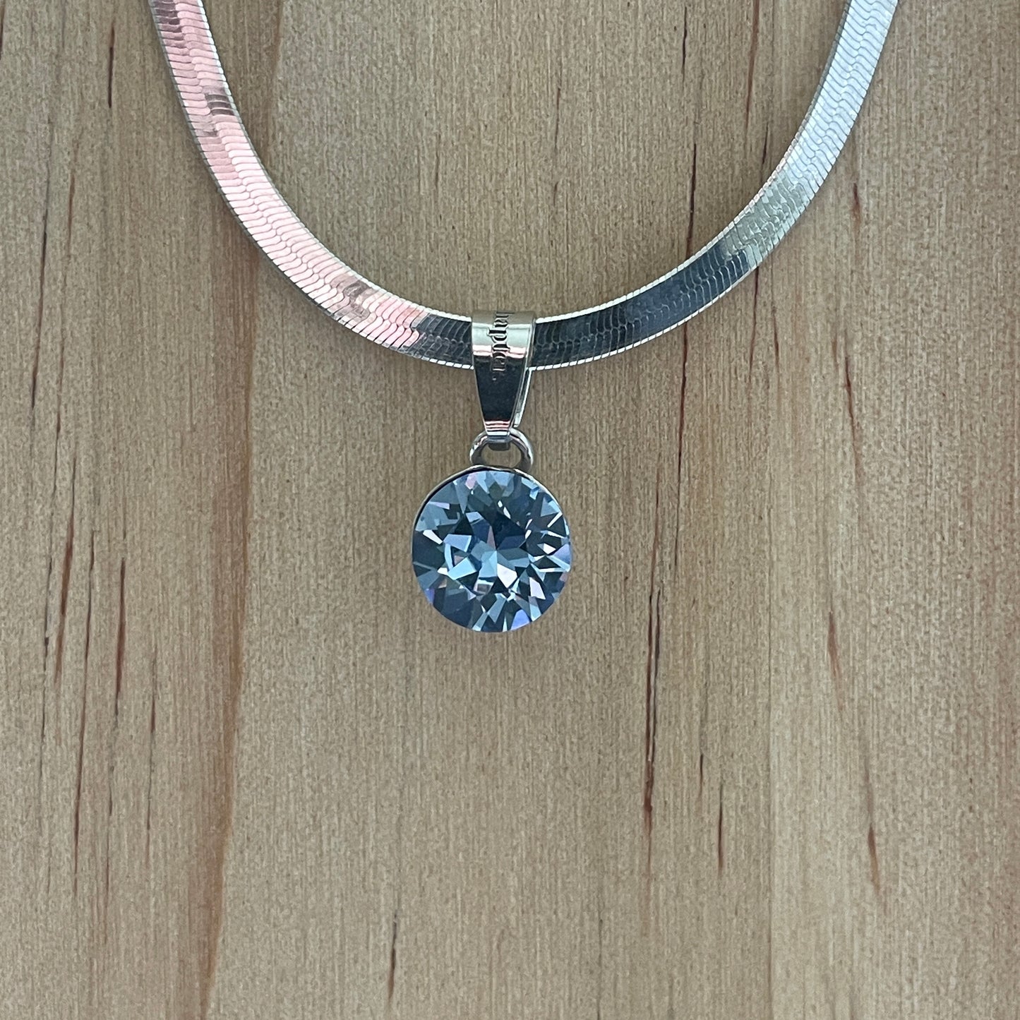 the SIMPLISTIC charm (Light Sapphire)