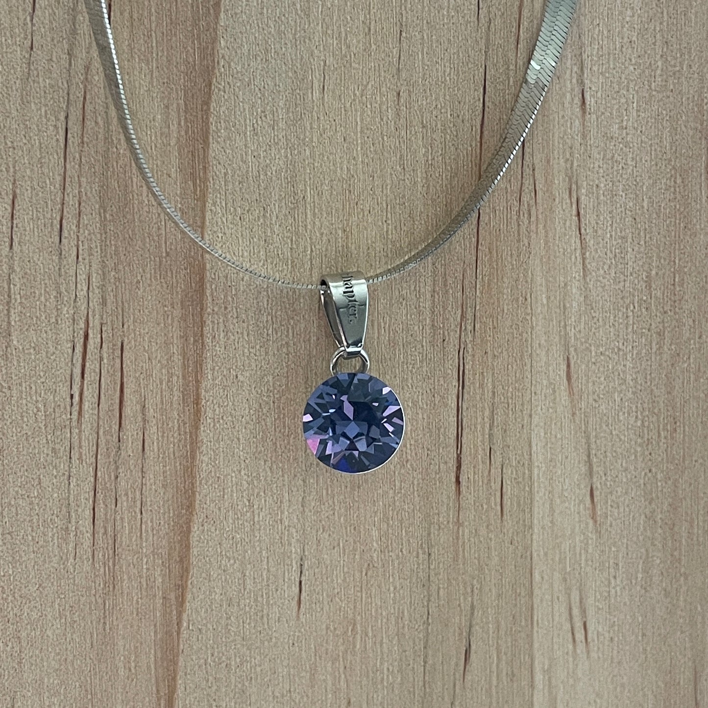 the SIMPLISTIC charm (Tanzanite)